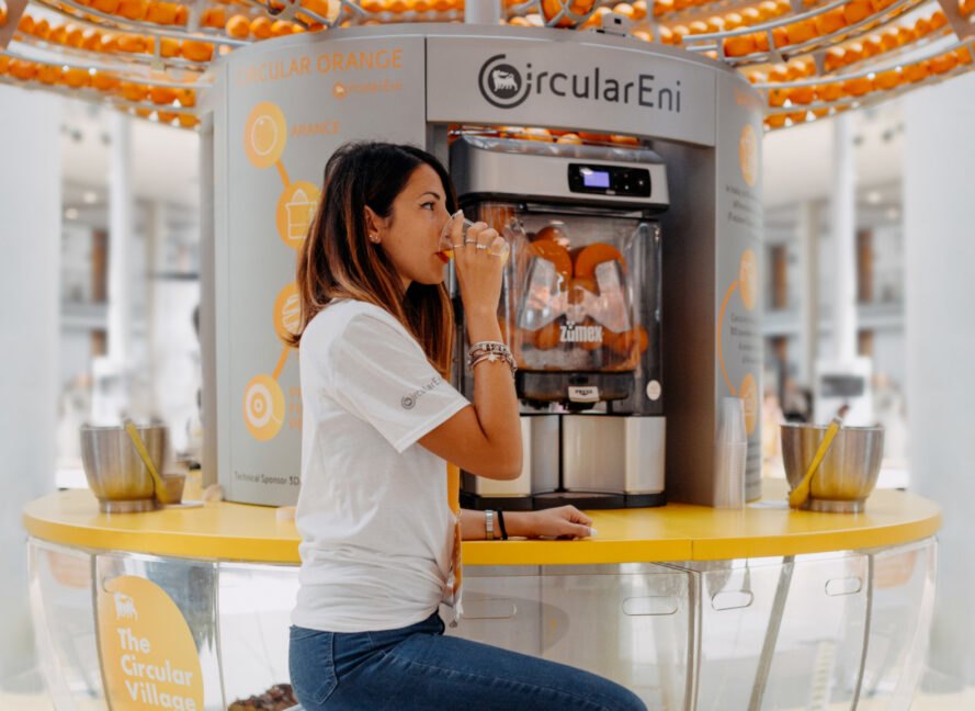 woman drinking orange juice at machine