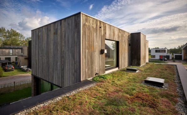 green roof leading to glass door of upper floor of a home