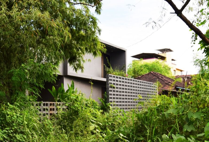 concrete home tucked into greenery